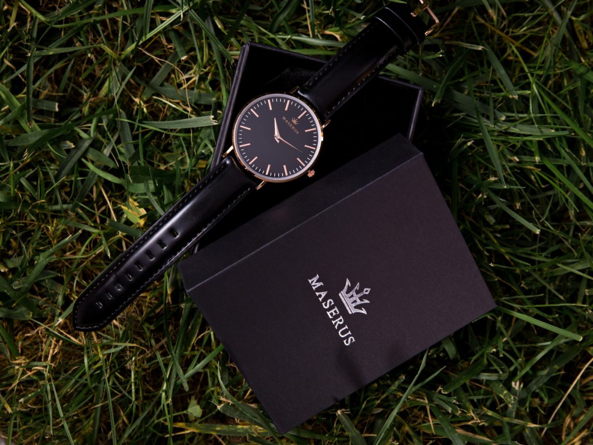 Product image three of womens rose gold, black leather strap watch on box.
