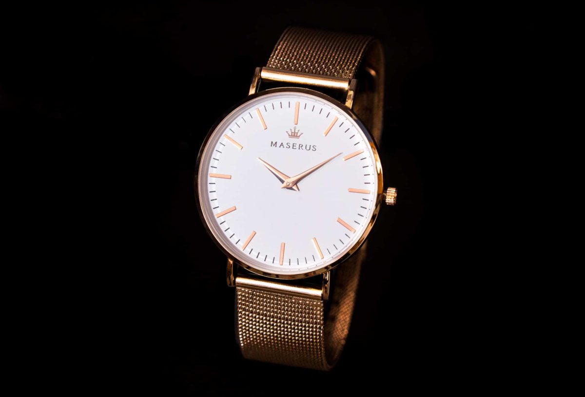 Product image one of womens rose gold mesh watch against black.