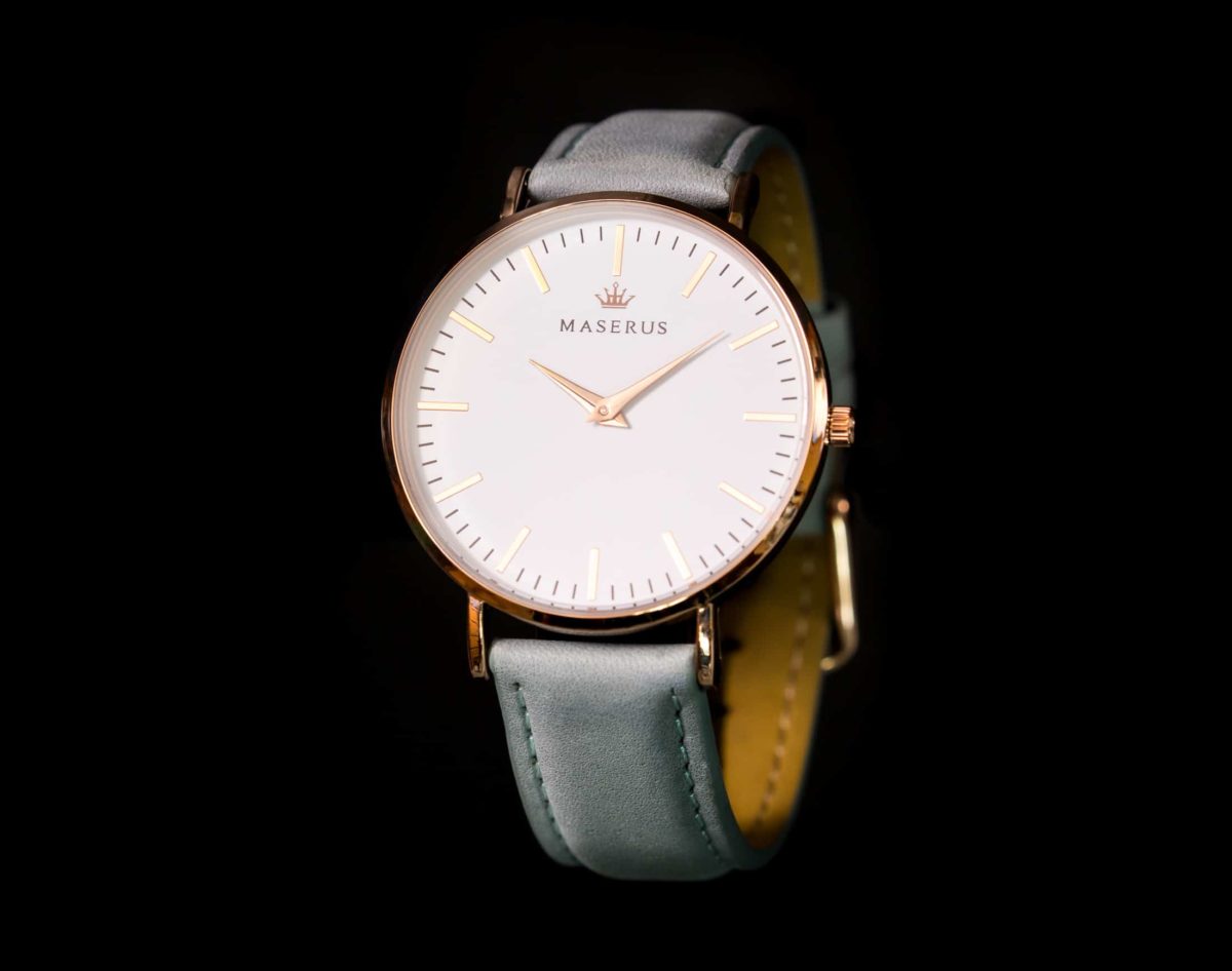 Product image one of womens rose gold, azure grey leather strap watch against black.