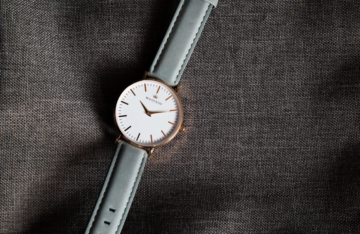 Product image two of womens rose gold, azure grey leather strap watch on fabric.